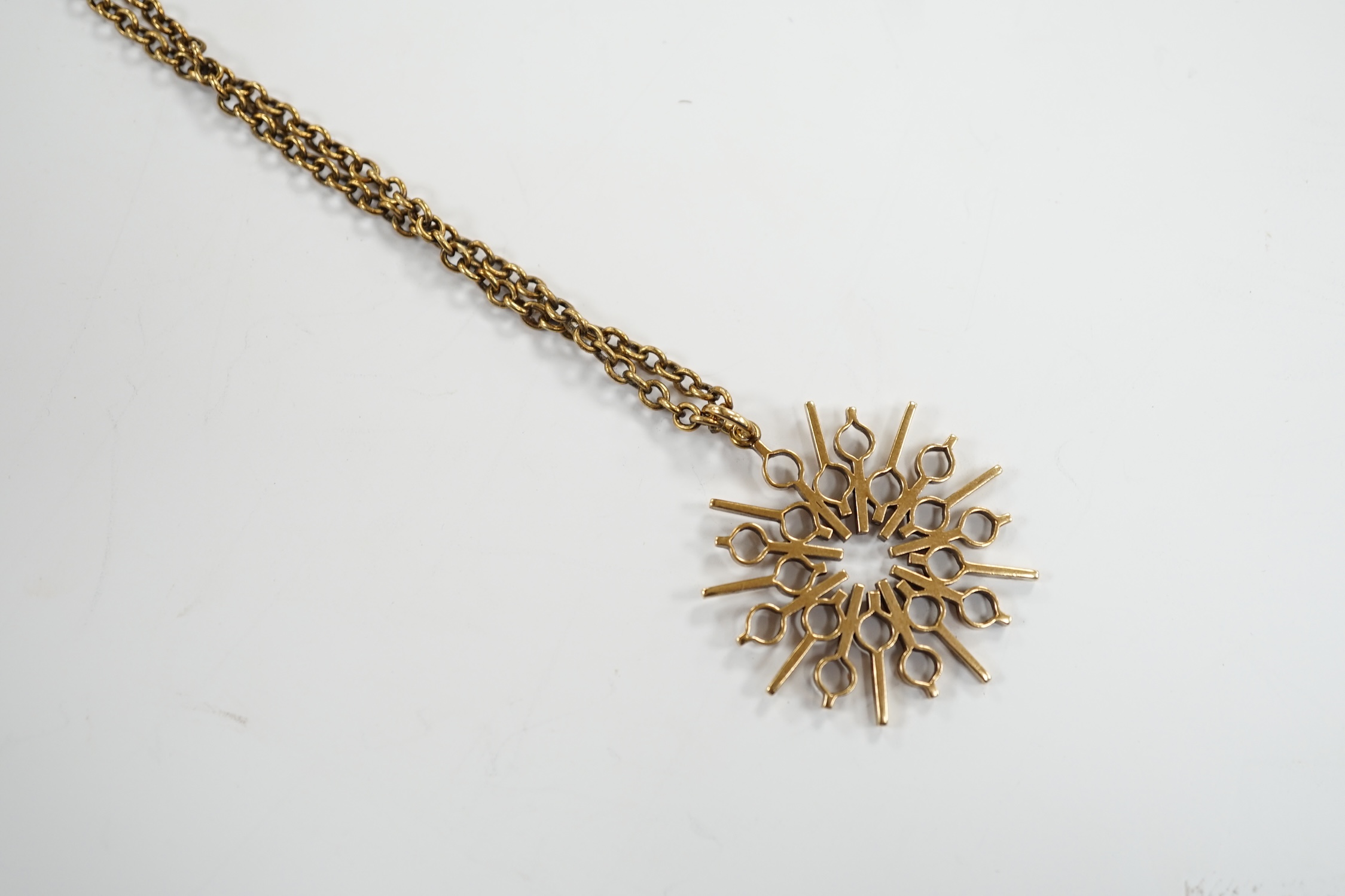 A yellow metal pendant, 37mm, on a 375 chain, 52cm, gross weight 17.8 grams.